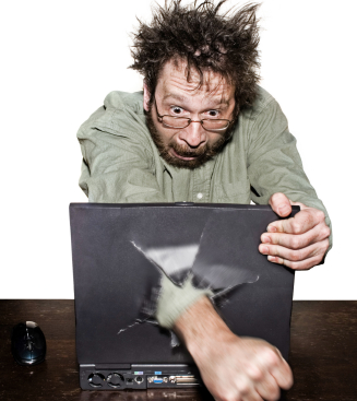 Wild-haired man punches fist through laptop screen